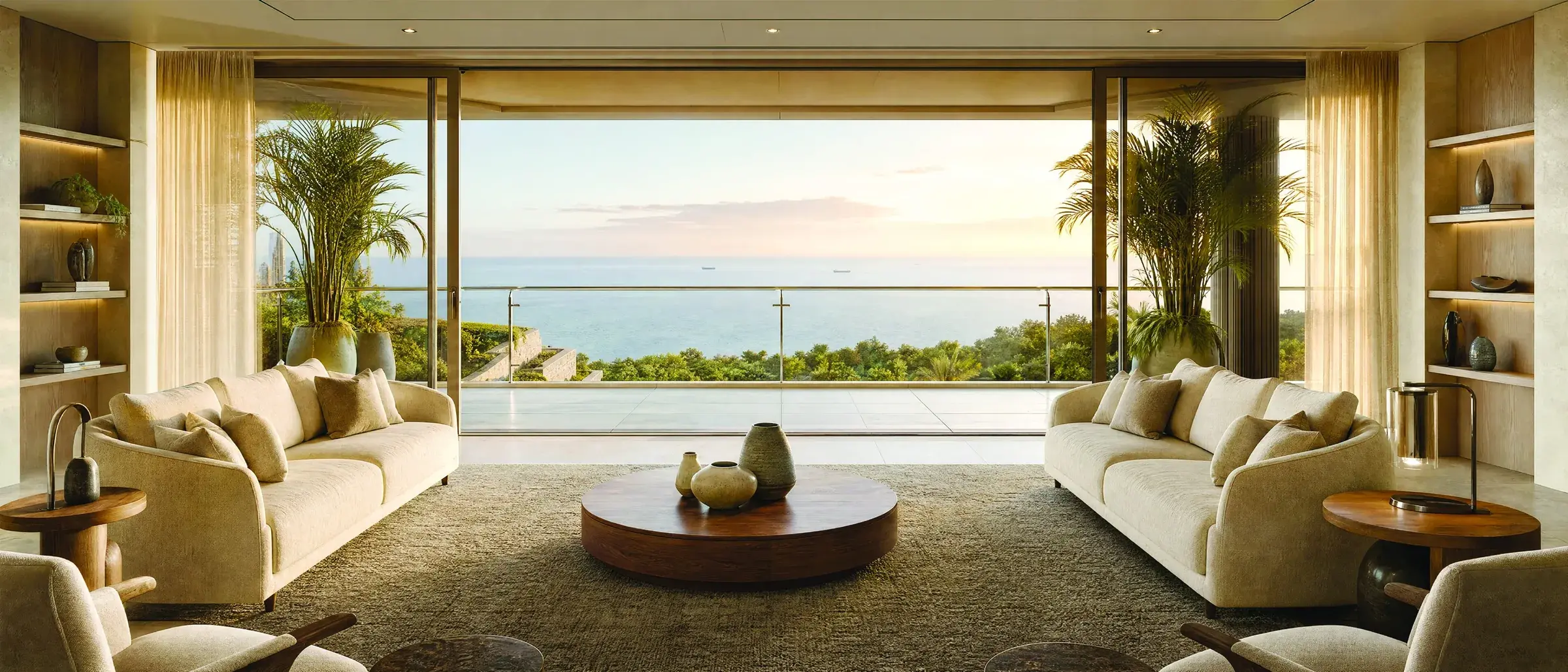 Living room opening onto a deck with views of the sea